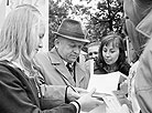 Writer Ivan Shamyakin gives autographs at an evening of poetry
