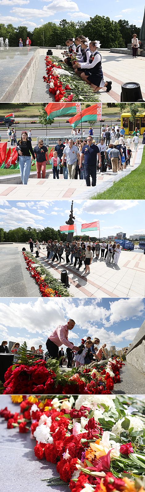 Народнае ўскладанне кветак каля стэлы 