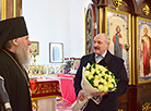 Alexander Lukashenko lights the candle in the Holy Transfiguration Church on Easter 