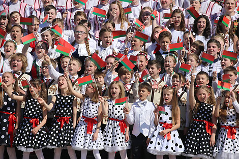 Thousands join the singing of the National Anthem in National Flag Square