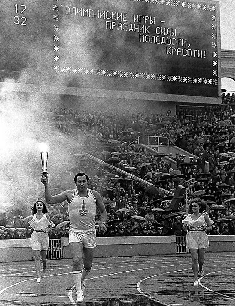 Three-time Olympic champion Alexander Medved carries the 1980 Olympics Torch at Dinamo Stadium