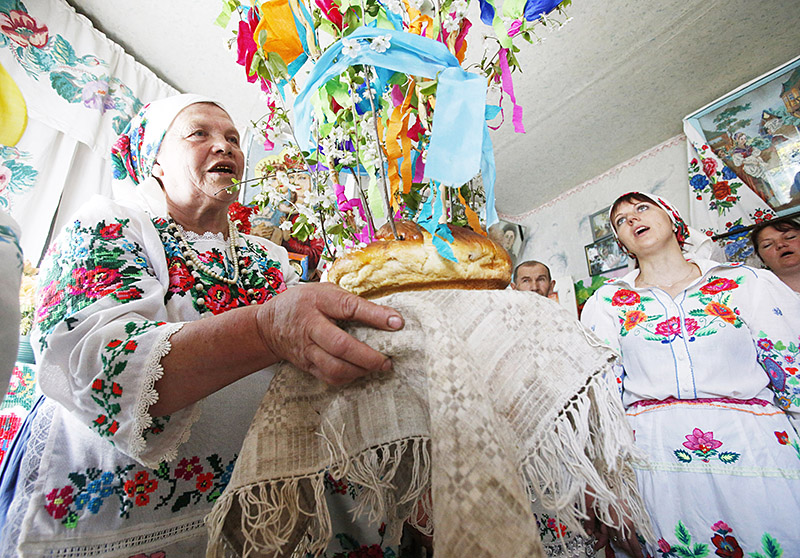 Katsiaryna Panchenya carries ceremonial bread called 