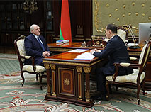 The head of state hears out a report of the prime minister