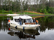 Tourists from Poland travel along Augustow Canal by yacht