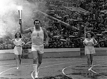 Three-time Olympic champion Alexander Medved carries the 1980 Olympics Torch at Dinamo Stadium