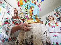 Katsiaryna Panchenya carries ceremonial bread called 